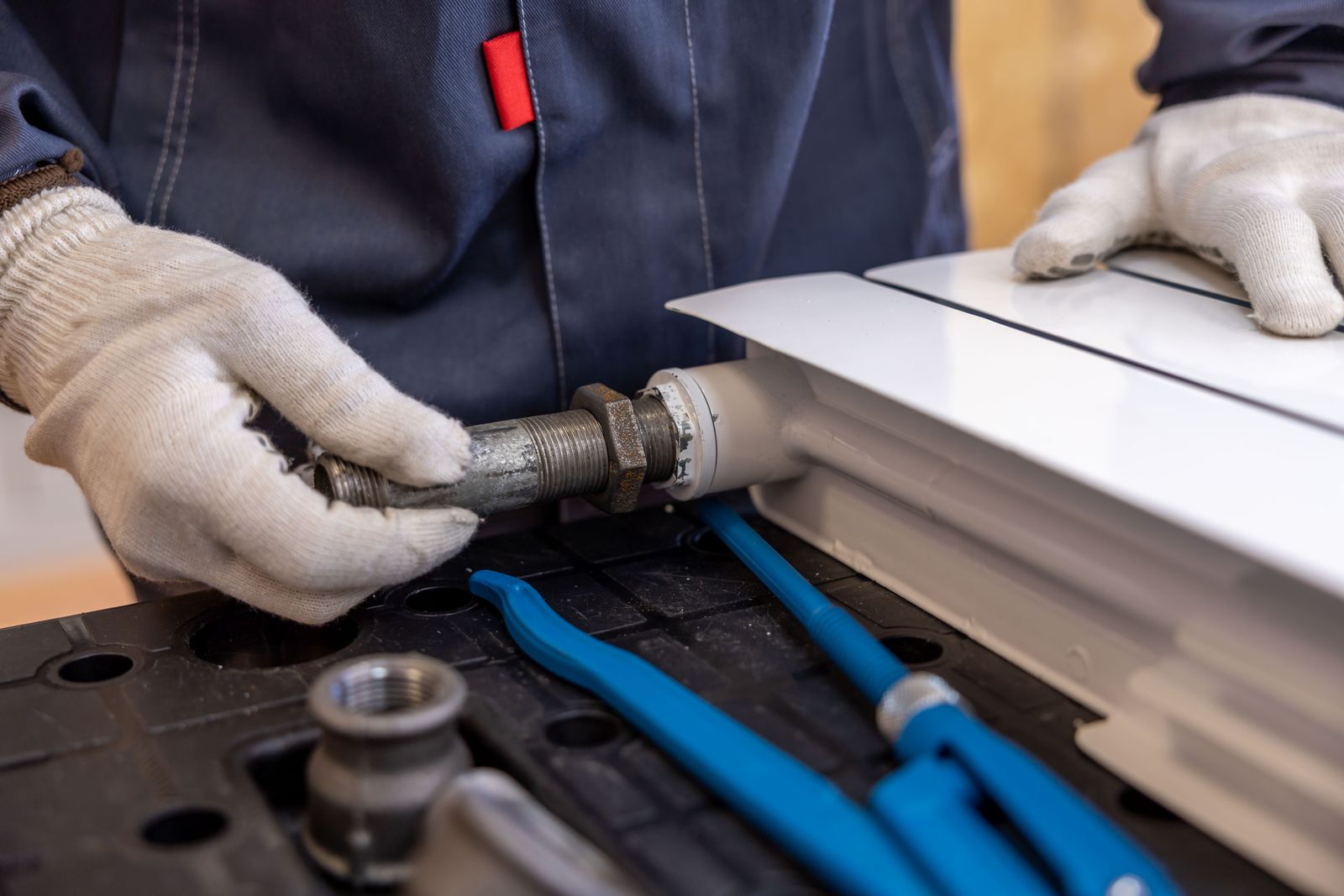 Plumber installing a pipe fitting